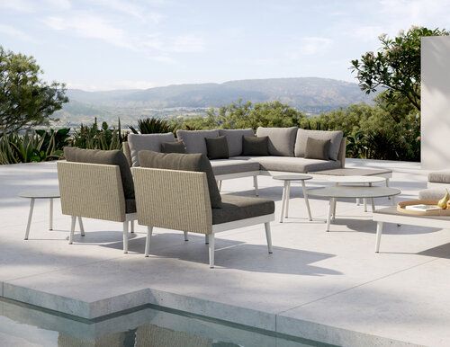 Modern outdoor living room set by pool.