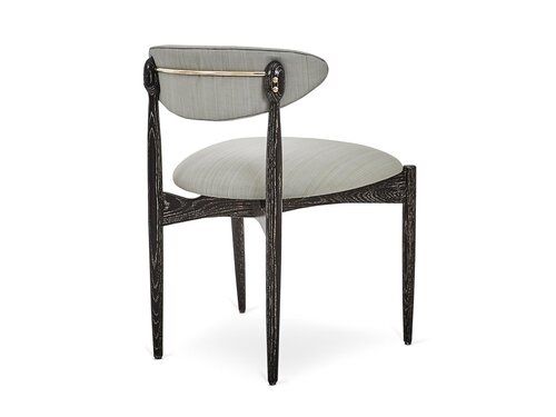 Mid Century Modern style side chair with upholstered seat and curved back.