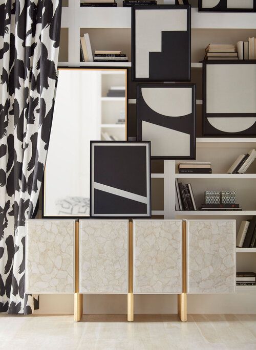 Credenza with mirrors and artwork on top and behind.