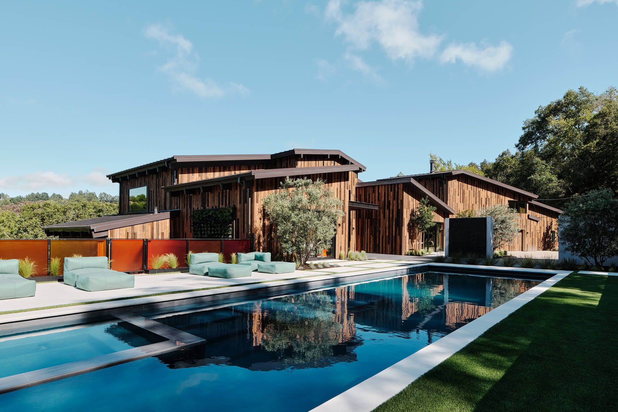 Mountain home with large pool and large oversized upholstered lounging couches.
