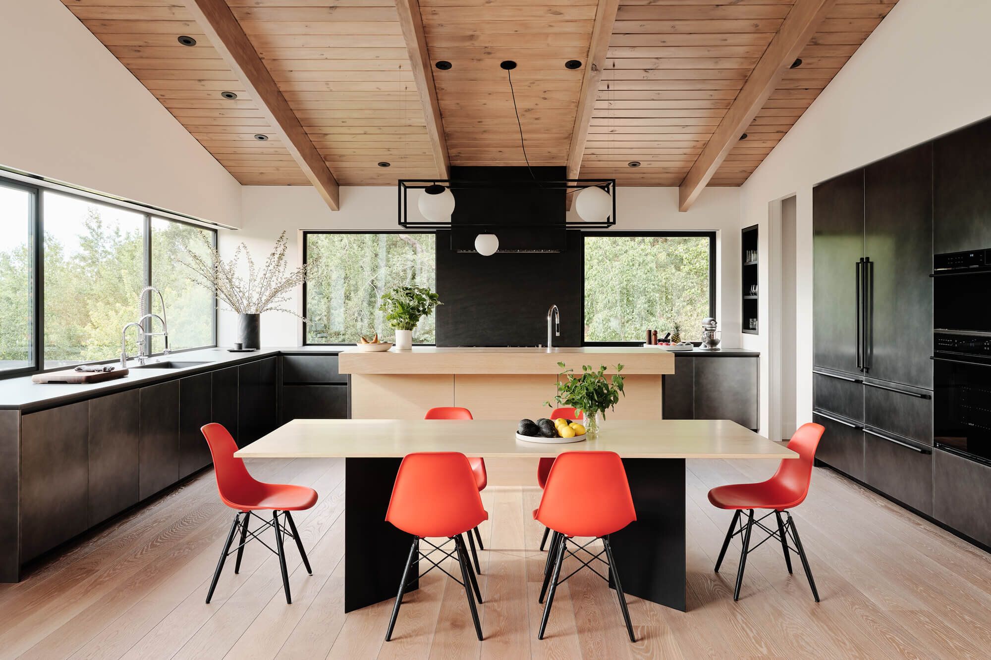 Open kitchen with large windows and low cabinetry.