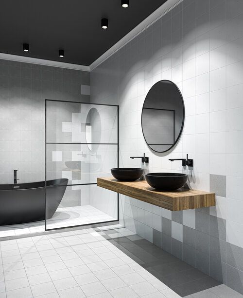 Spa bathroom with wooden slab counter, stone basin sinks and soaking tub with tiled walls and floor.