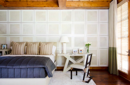 Square light color wall blocks stacked across a wall in a bedroom.