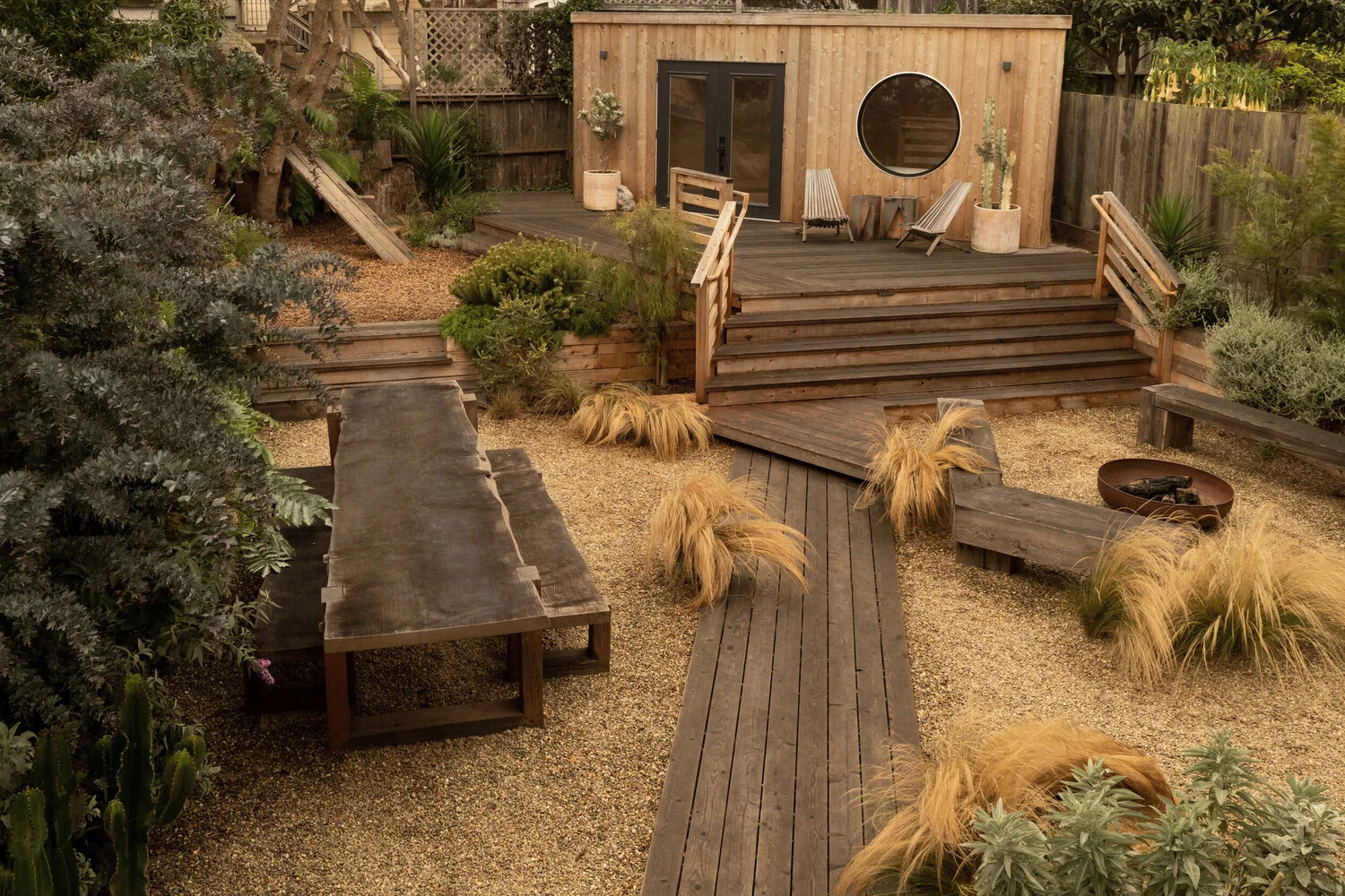 Small guest house with a variety of surfaces of decks and growing areas.