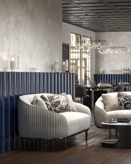 Wavy patterned wainscotting behind curved upholstered furniture.