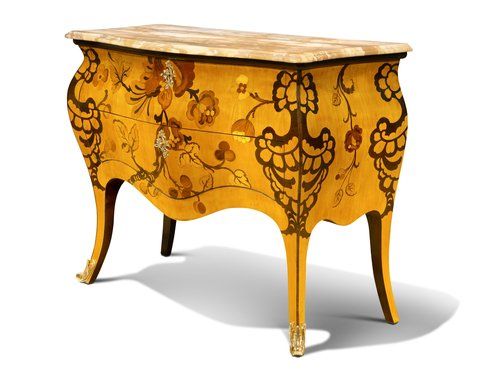 Small chest of drawers with inset wood design.