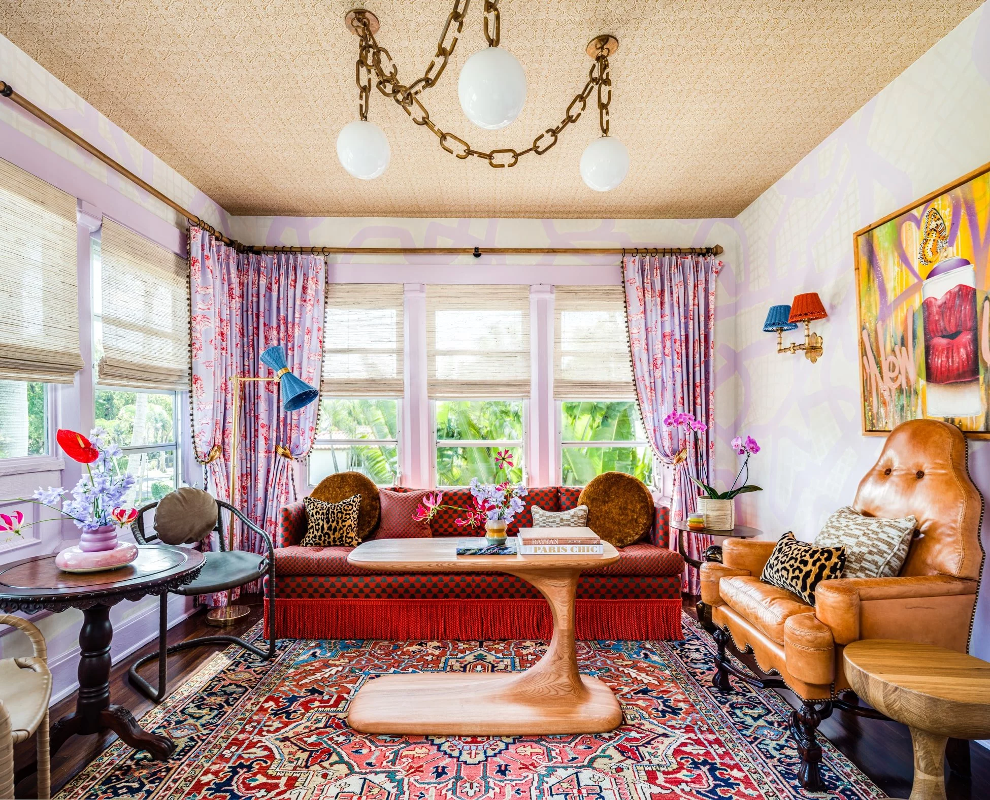 Well-lit sunroom with cozy patterns and accessories.