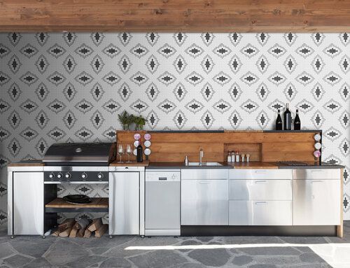 Stainless steel cabinetry with rough wood backsplash and mosaic tiled wall.