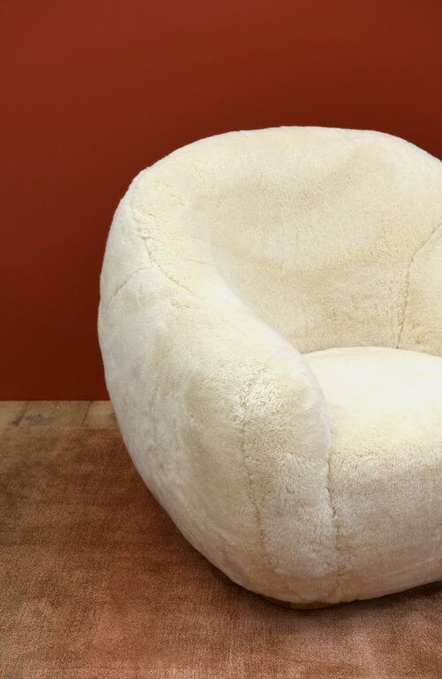 All over fuzzy curved armchair.