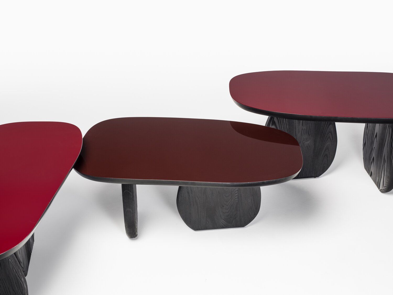 Uneven oblong cocktail tables with unique legs.