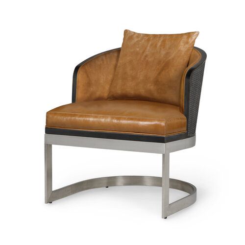 Curved back leather chair with matching throw pillow on a half-moon shaped stainless base.