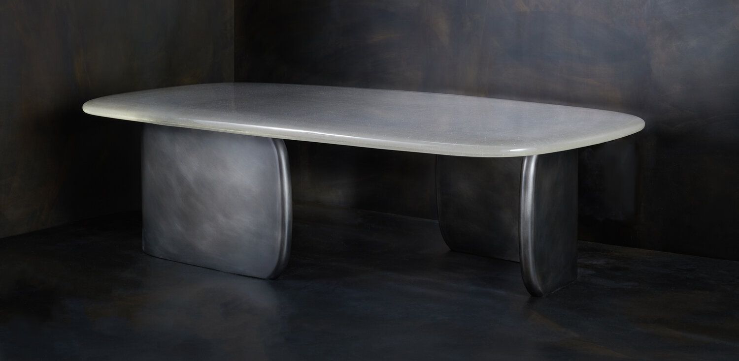 Smoky glass table with slabs of glass for legs.