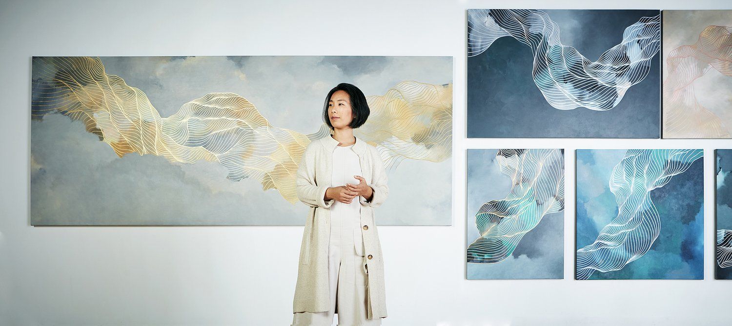 Artist in front of her works.