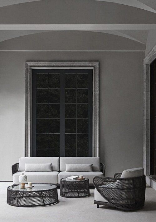 Outdoor living room set with woven curved tables and chair base.