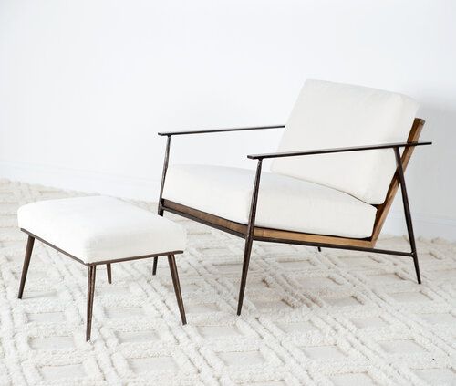 Low slung upholstered chair and ottoman with metal frames.