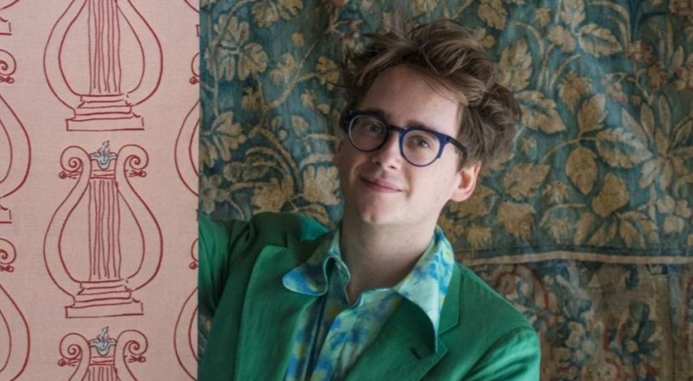 Young man against a multi-patterned background.