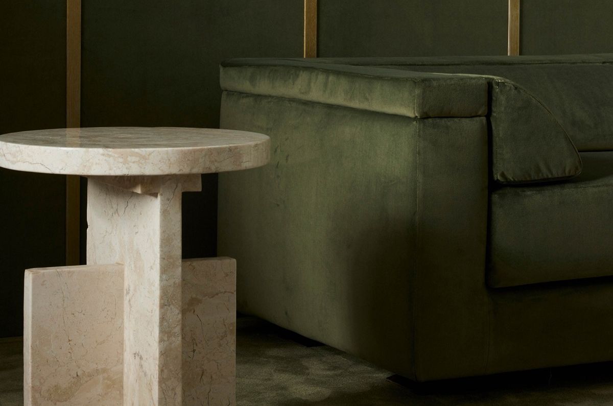 Beautiful modern living room with a modern patterned rug and highly stylized couch in foreground.