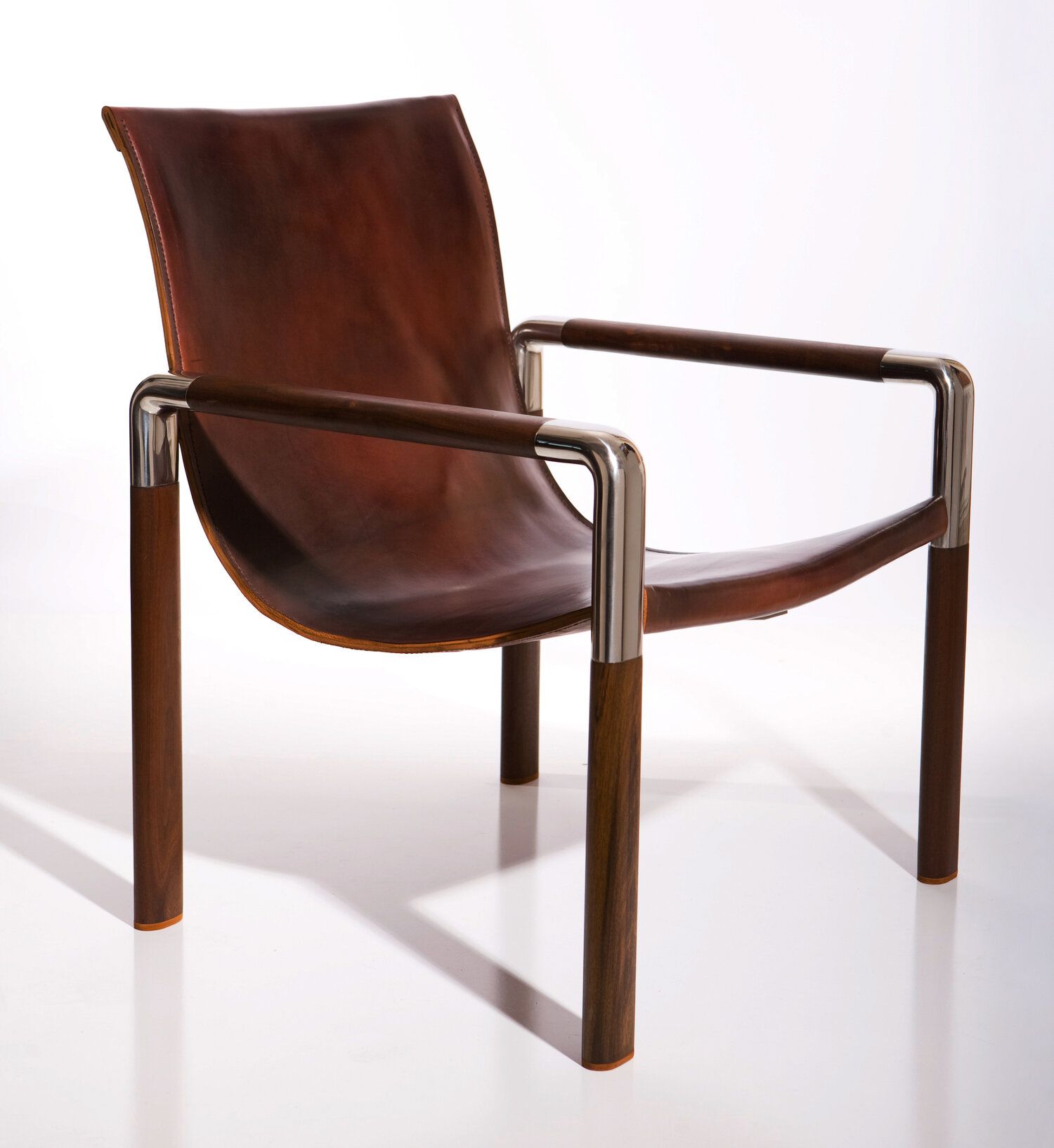 Leather sling chair with stainless steel frame.