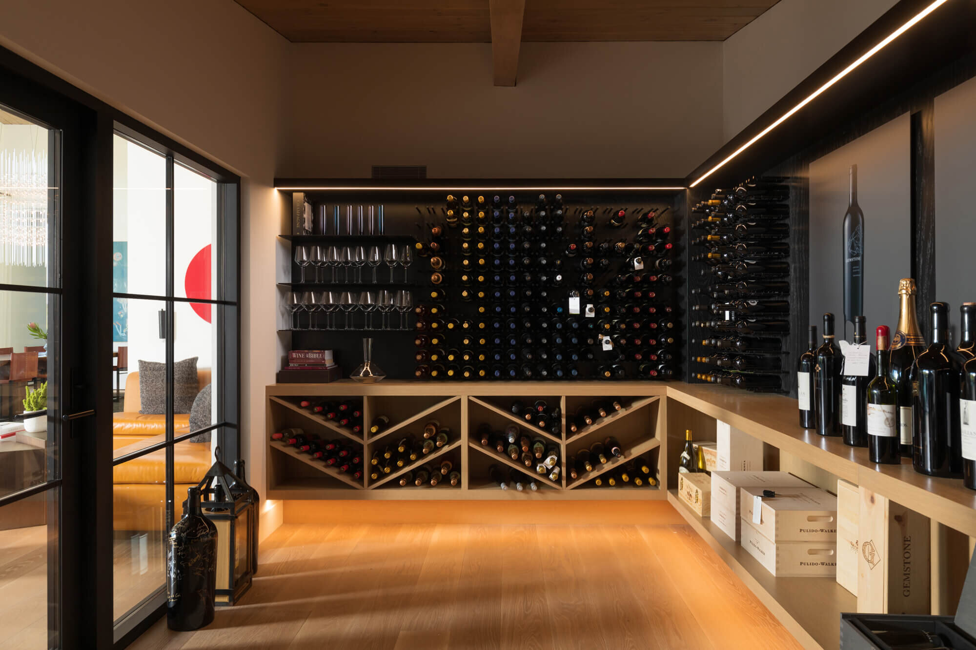 Wine storage room with large paned glass wall.