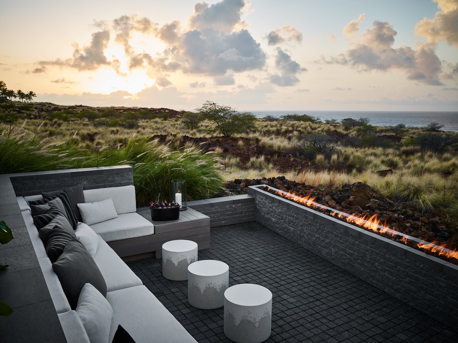 Terrace of home with pit seating, gas firewall and view out over the beach and ocean.