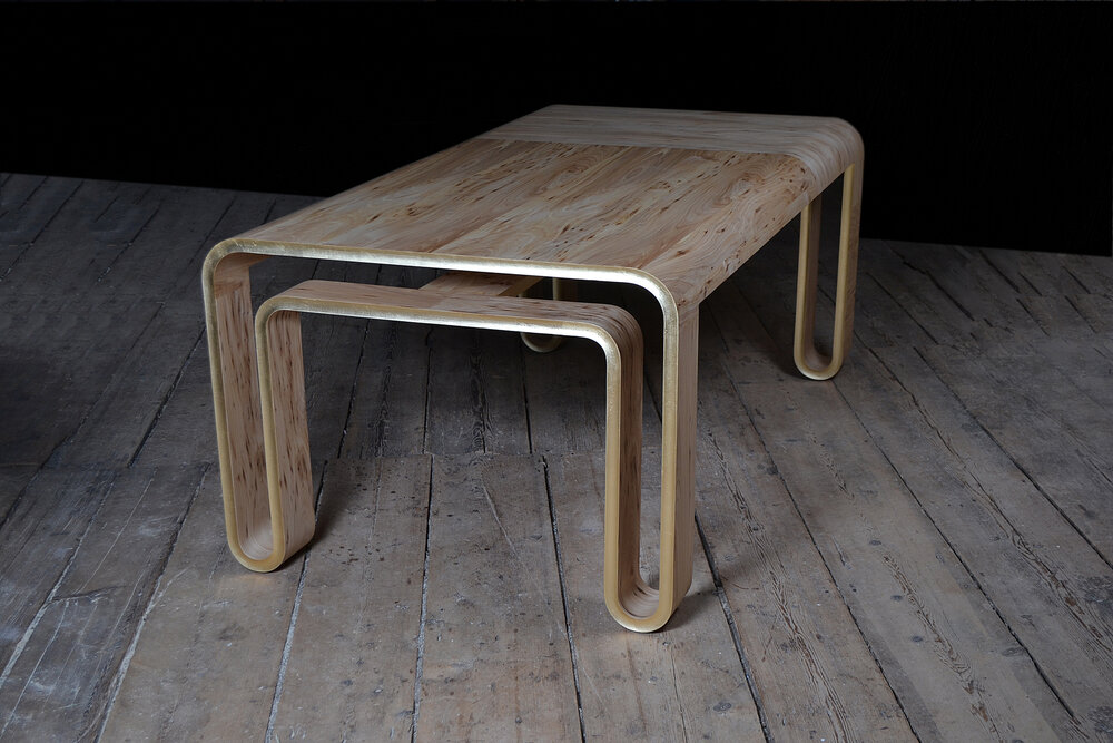 Metal bench with shaped double legs.