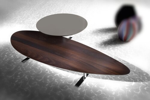 Oblong coffee table with attached smaller, higher round table surface.