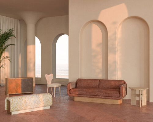 Living area with arched inset walls and windows, and curved edged upholstered furniture.