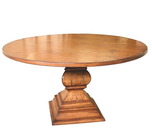 Round traditional wooden table with carved pedestal base.