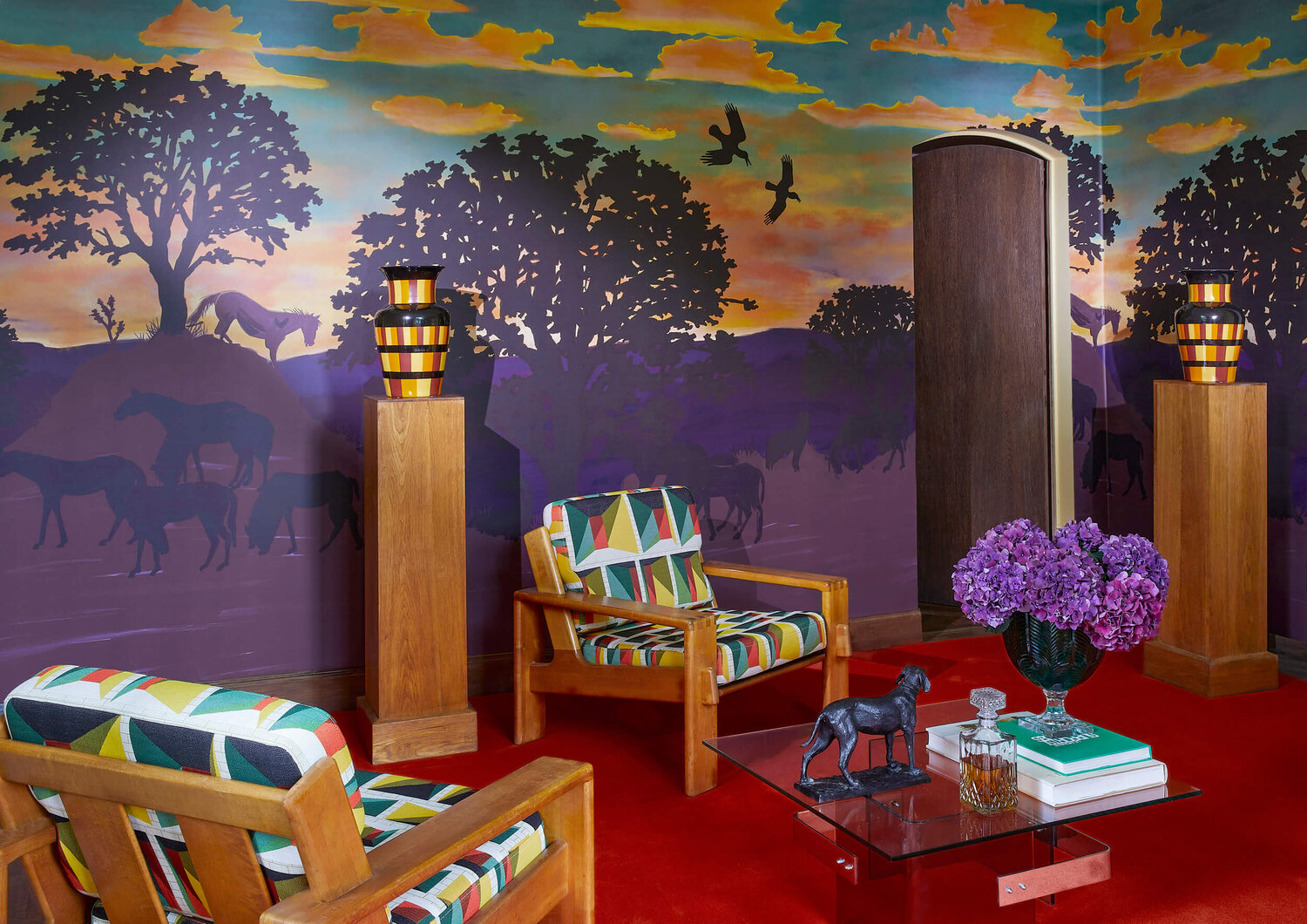 Wallcovering that appears to be a colorful scene of horse, birds, trees, hills and sky.