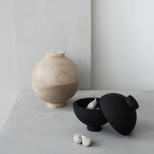 Two spherical bowls with covers.