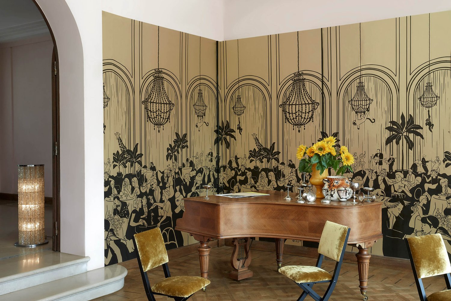 Wallcovering that provides a graphic mural in the corner of a room that resembles a jazz era busy club. In foreground is a beautiful piano and simple seating.