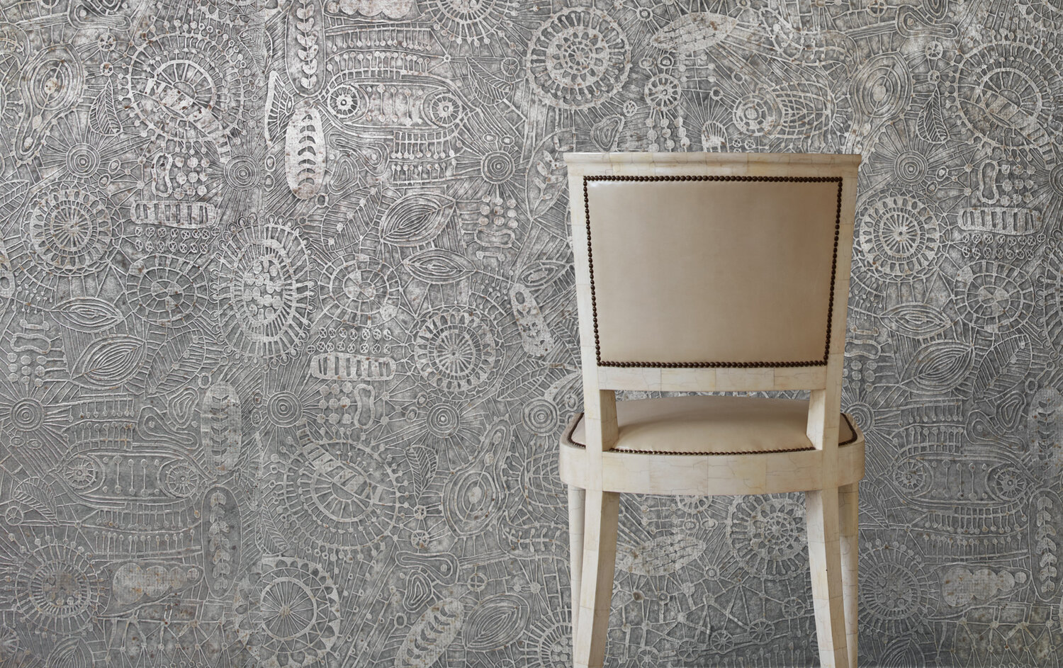 Tone-on-tone wallcovering that looks like it is made up of randomly placed crocheted doilies.