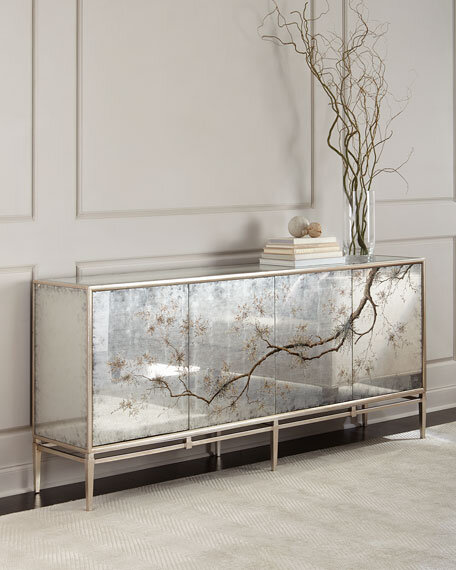 Credenza with smoky mirrored glass front with a design of a budding bough on it.