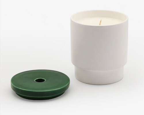 Candle in ceramic container with lid removed.