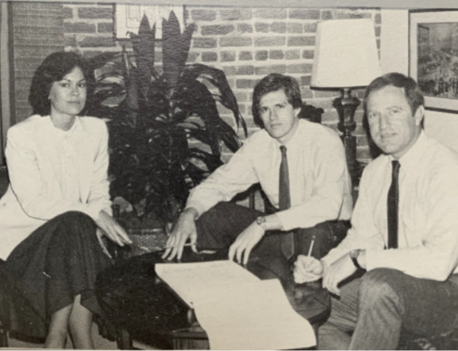 Vintage photo of two men and a woman in business clothes.