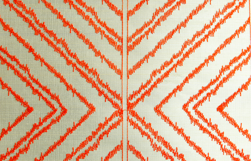 Closeup of fabric pattern with intersecting arrows.