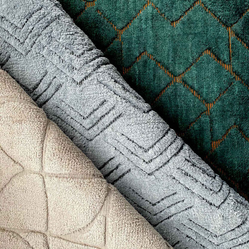 Closeups of several cut pile patterned rugs.