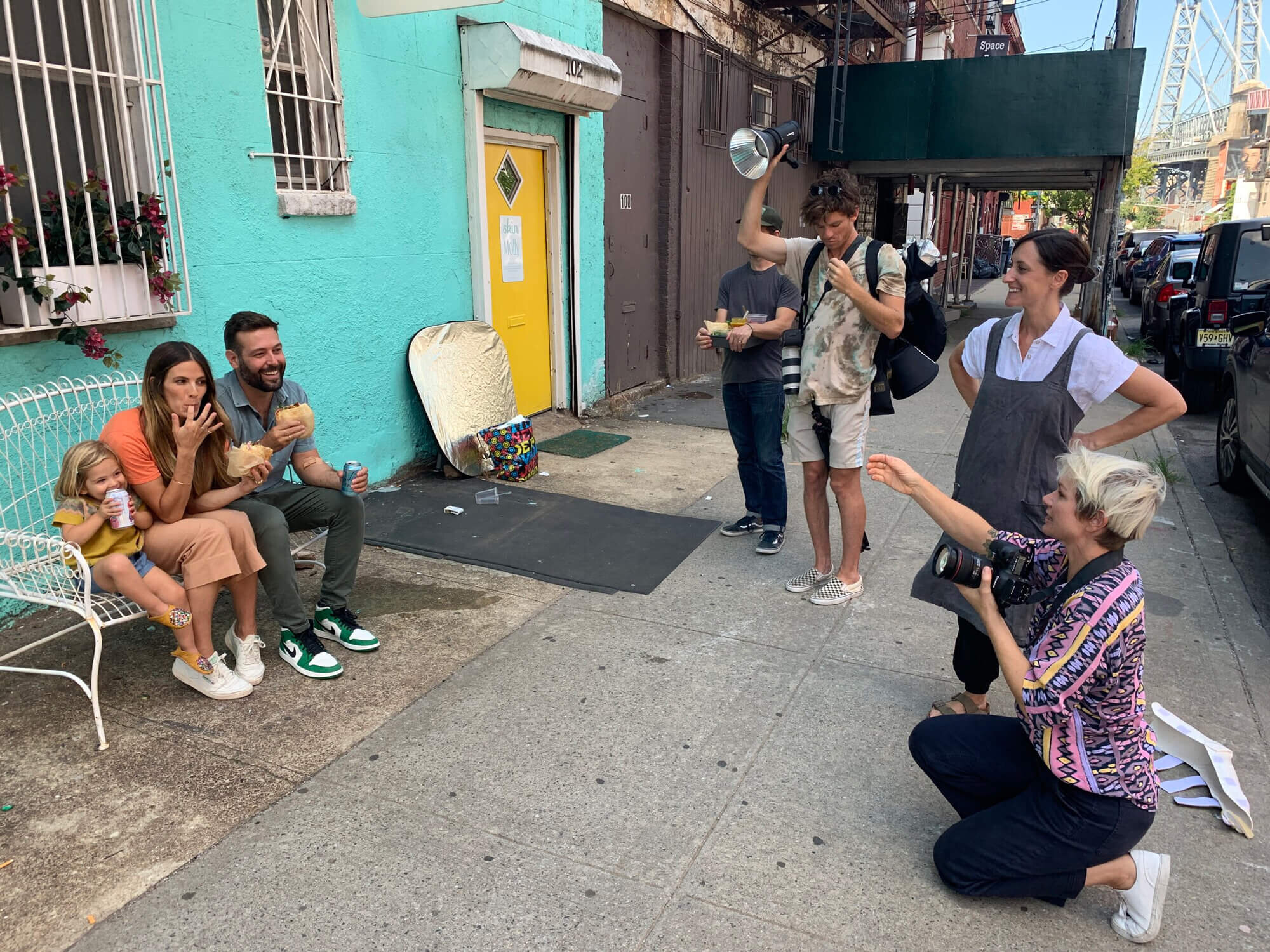 Photographer taking picture of family eating.
