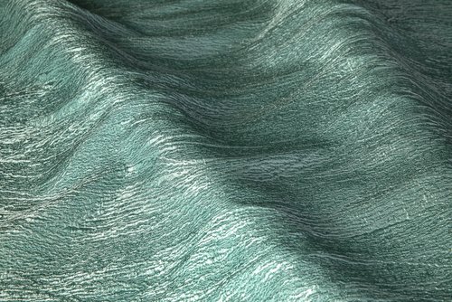 Fabric draped to look like waves and fabric has a wavy motif.