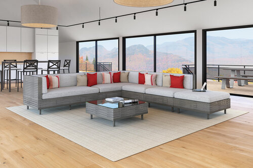 Large modern living room with walls of glass overlooking deck and mountains.